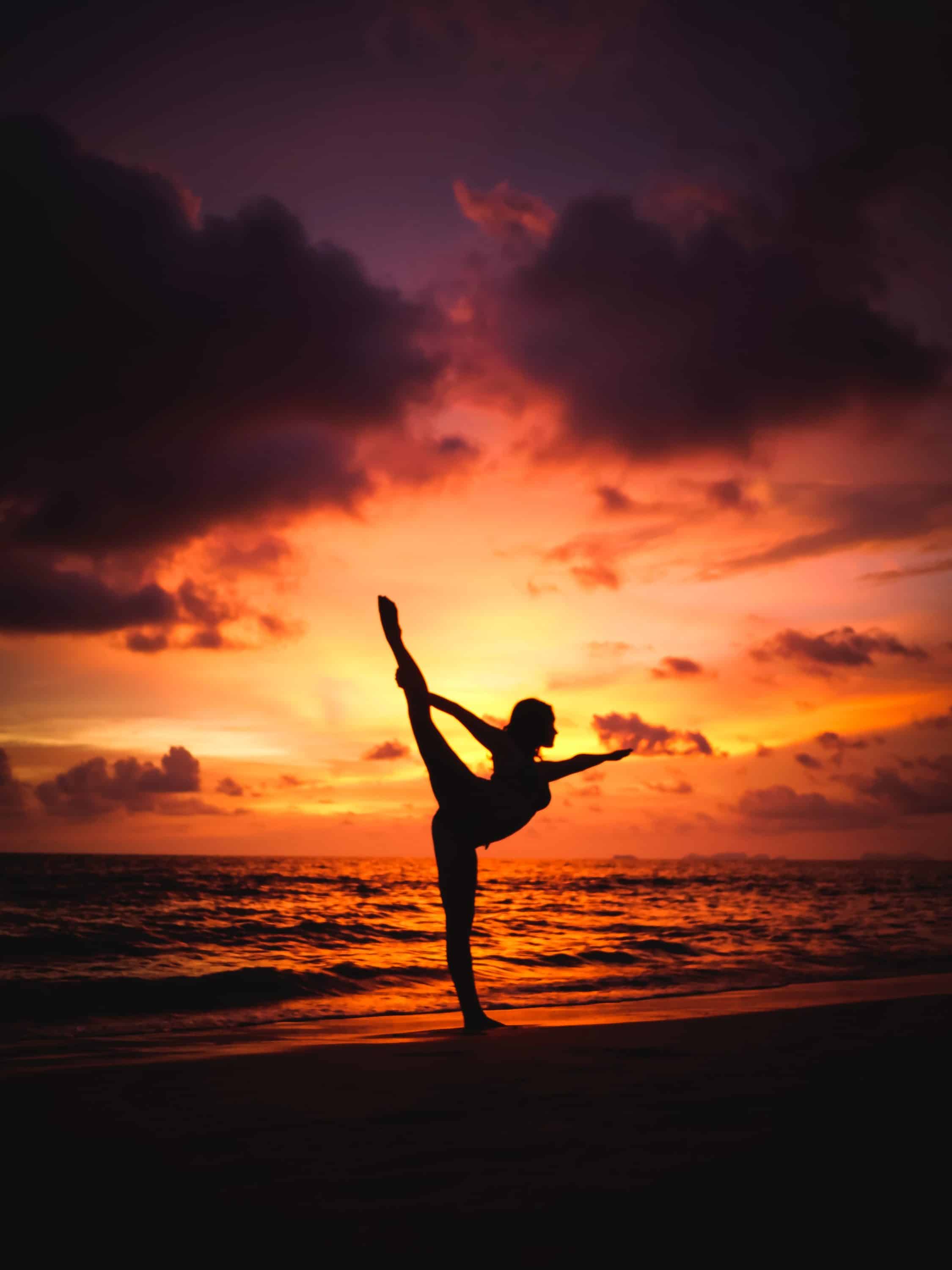 Dancer's Pose with a beach sunset